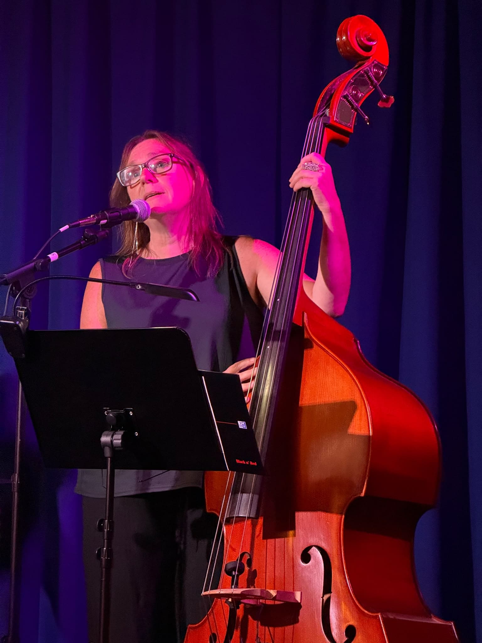 Helen Staniland singing and playing double bass at Pop Up Jazz Club